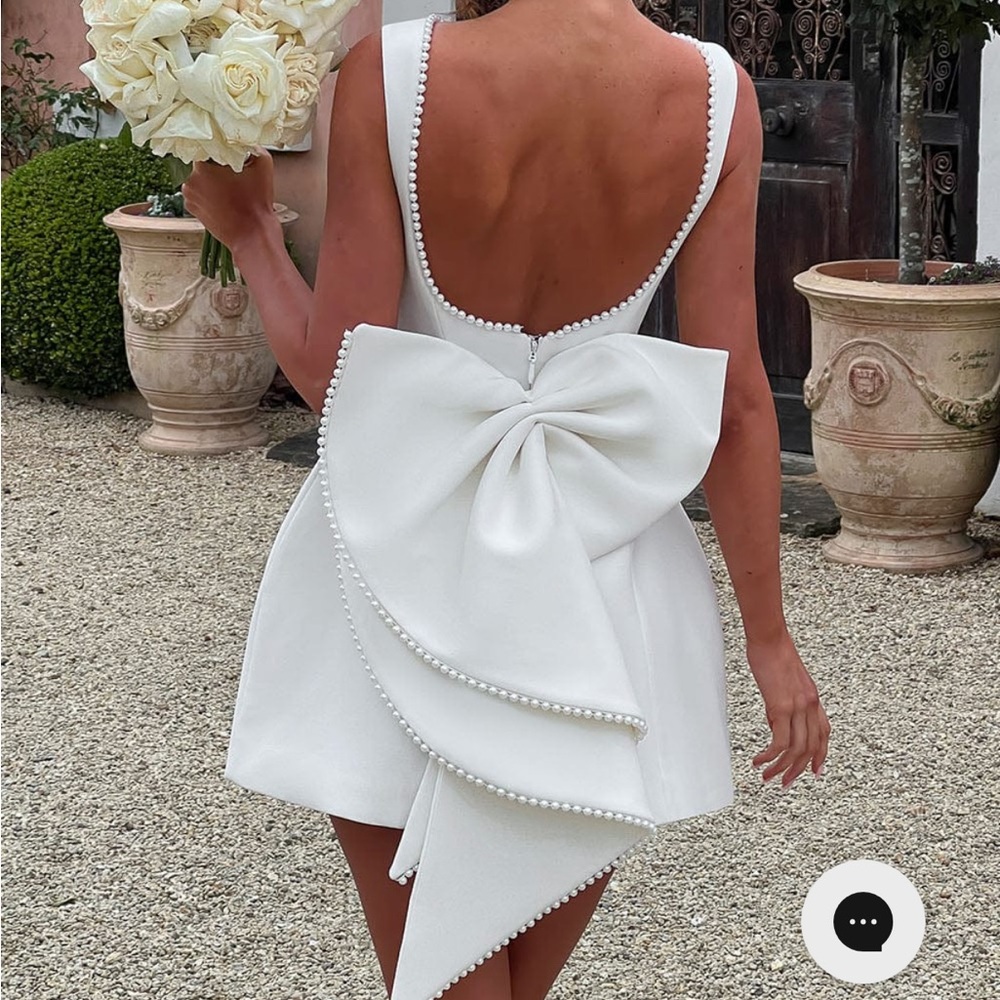 Carrie Mini Dress by Babyboo Fashion. Chic White Backless Dress with Bow Detail